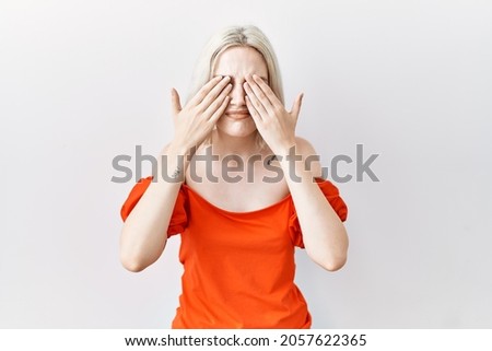 Young caucasian woman standing over isolated background rubbing eyes for fatigue and headache, sleepy and tired expression. vision problem 