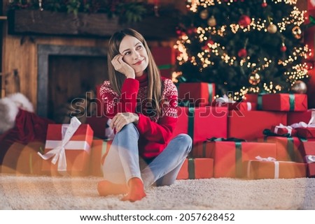 Photo of pretty adorable young woman dressed red sweater arm cheek hand cheekbone celebrating new year indoors room home house