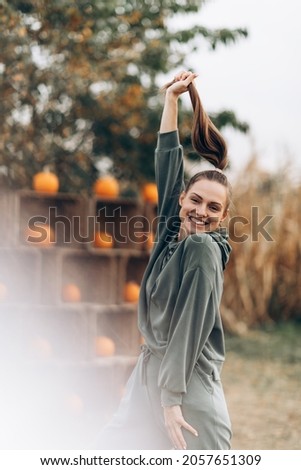 Beautiful happy girl on the background of pumpkin decorations. High quality photo