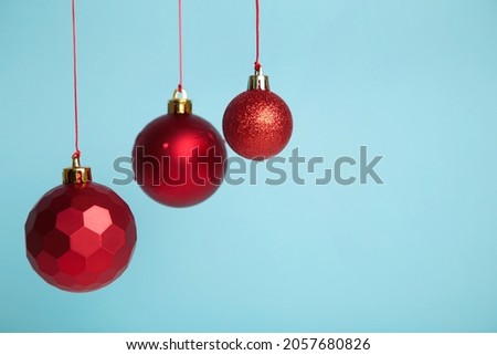 Red Christmas balls on blue background. Top view