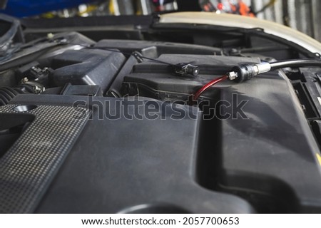 Auto mechanic Filling the New Automatic Transmission Fluid in Transmission Fill Hole. Royalty-Free Stock Photo #2057700653