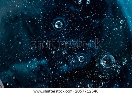 Liquid smear,cosmetics swatch on the navy blue background.Top view,antibacterial liquid surface.Good as background or mockup,large banner.