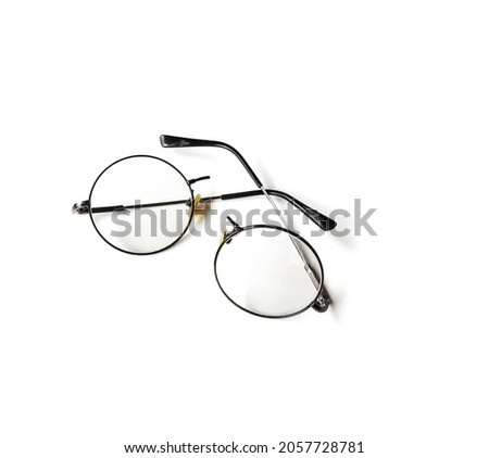 Black round frame eyeglasses have broken. It was broken in half into two pieces, placed on a white background. Royalty-Free Stock Photo #2057728781