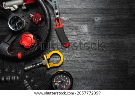 Car tuning equipment and accessories on the black table flat lay background. Royalty-Free Stock Photo #2057772059