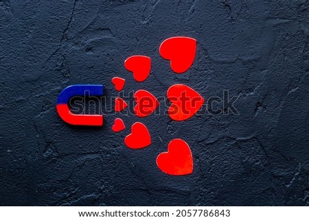 Horseshoe magnet with heart shapes. Love and dating concept