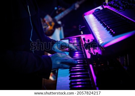 Hands of a musician playing keyboard in concert Royalty-Free Stock Photo #2057824217