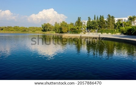 Lake Titreyengel. A trembling lake. Sorgun. Side. The resort village of Titreyengol on the shores of a trembling lake in Turkey. The water in the lake is clear, in many places you can see algae Royalty-Free Stock Photo #2057886470
