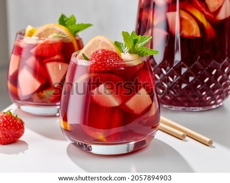 close up of red sangria glasses on white kitchen table Royalty-Free Stock Photo #2057894903