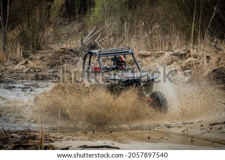 ATV, UTV, 4x4 driving in muddy water Royalty-Free Stock Photo #2057897540