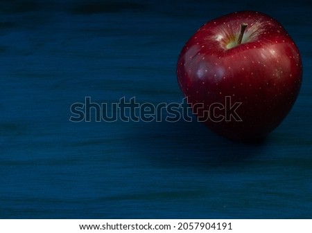 red apple and blue background