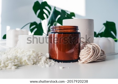 Handmade ecological and vegan soy wax candles with wooden wick. Amber and opaque container. Mock up, space for text Royalty-Free Stock Photo #2057920238