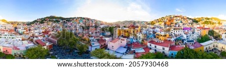 Aerial hyperlapse over the beautiful magical town of Guanajuato with a special sunset in the background Royalty-Free Stock Photo #2057930468