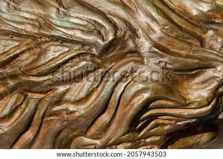 Close-up photo texture of copper or bronze statue hair  material with folds.