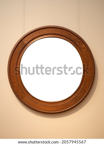 Vintage Round shape wooden frame hanging on wall with empty space 