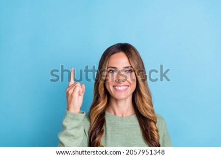 Photo portrait woman smiling pointing fingers up empty space got idea isolated pastel blue color background