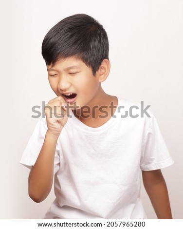 Asian boy coughing on white background Royalty-Free Stock Photo #2057965280