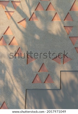 Exterior wall decoration with geometric elements and sunlight. Wall for background. Copy space, Selective focus.
