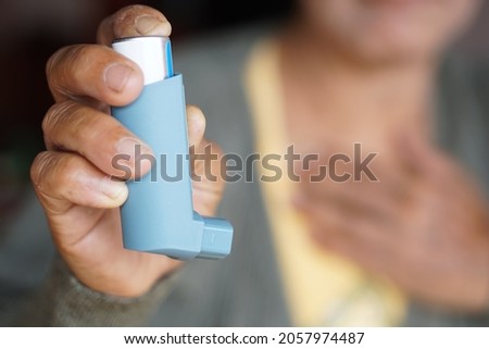 Blue asthma inhaler. Concept : Health care at home.  Pharmaceutical products for treatment symptoms of asthma or COPD. Use under prescription.                               Royalty-Free Stock Photo #2057974487