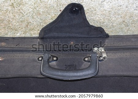 Black hard case for violin isolated on cement wall. Copy space concept, classic and old times.