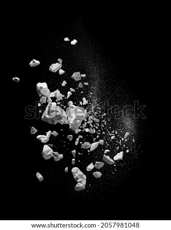 broken debris caused by explosion against black background Royalty-Free Stock Photo #2057981048