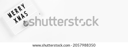 Merry Christmas text on lightbox on a white background. Horizontal long banner for web design with copy space