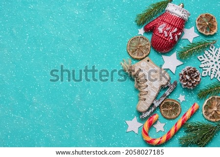 Christmas and New Years concept. Christmas decorations, sweets, Santa Claus hat on a green background. Flat lay. There is a place for text.