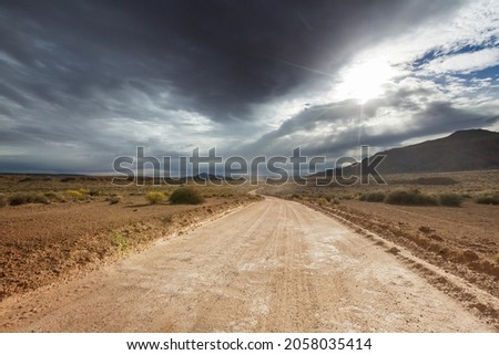 Road in the prairie country. Deserted natural travel background. Royalty-Free Stock Photo #2058035414