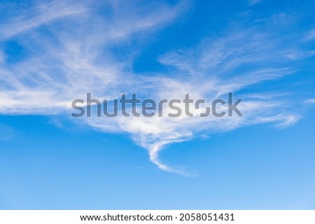 Delightful stratus high-altitude clouds with swirl stripes. Background with white clouds. Picture for weather forecast. 