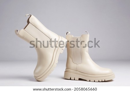 beige Trendy boots. fashion female shoes still life. stylish chelsea boots Royalty-Free Stock Photo #2058065660