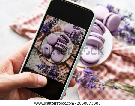 Food photography concept. Photo of French desserts macaroon with lavender taken on a smartphone