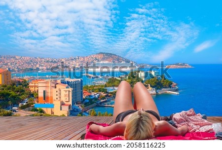 Blondie girl relax on the beach -  Cruise ships at port of Kusadasi - Aydin, Turkey