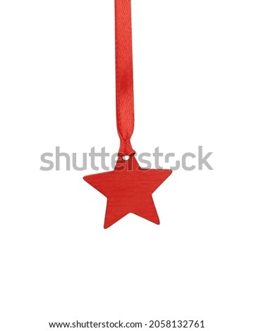 Red decorative wooden star on red satin ribbon isolated on white background. Christmas holiday decoration, festive ornament.