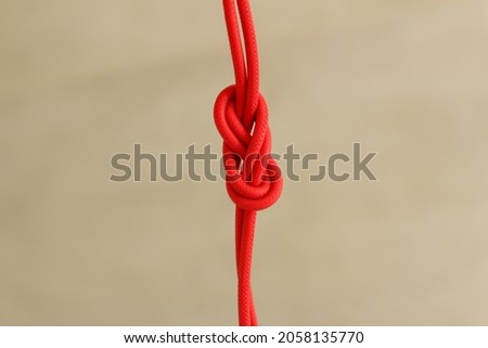 a strong knot on a red rope