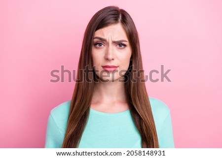 Photo of unsure pretty young lady wear teal t-shirt looking you isolated pink color background