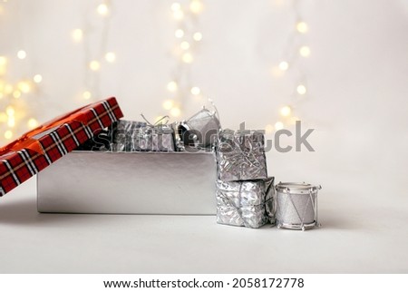 close-up of a gift box with toys on a white background with a bokeh with a place for text