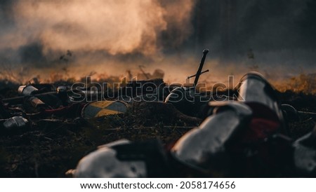 After Epic Battle Bodies of Dead, Massacred Medieval Knights Lying on Battlefield. Warrior Soldiers Fallen in Conflict, War, Conquest, Warfare, Colonization. Cinematic Dramatic Historical Reenactment Royalty-Free Stock Photo #2058174656