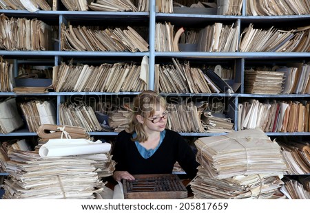 young woman working in an oldfashioned office Royalty-Free Stock Photo #205817659