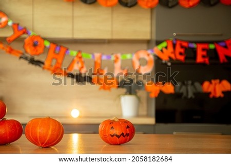holiday halloween kitchen decorated with orange pumpkins