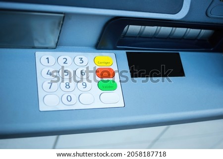 View from above of new ATM keypad numbers with french text engraved on yellow green red button Correct Cancel and Approve