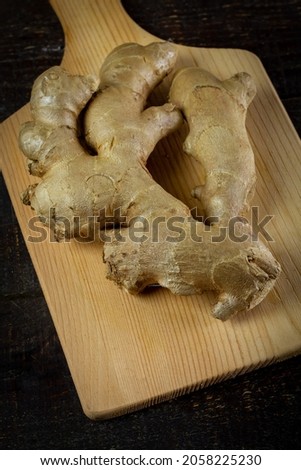 Fresh ginger on rustic wooden background. Ginger is a food and herb for healthcare.