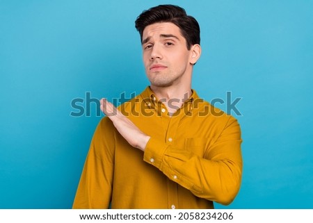 Photo of arrogant boyfriend guy hand shoulder look camera wear yellow shirt isolated blue color background