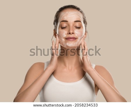 Soap face woman clean skin beauty. Color background. Brown Royalty-Free Stock Photo #2058234533