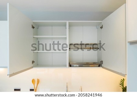 Dish drainer set ,Dish drainer for hanging cabinet for door width 600 mm. and cabinet with adjustable shelves. Open wall cabinet. Royalty-Free Stock Photo #2058241946