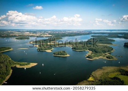 Masuria. Aerial view of green islands and clouds at summer sunny day. Masurian Lake District in Poland.  Royalty-Free Stock Photo #2058279335