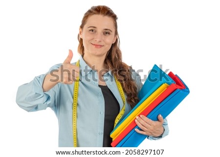 Stylish woman tailor holding cloth and scissors with measuring tape around his neck. Female character clothing designer, fabric seller on an isolated white background