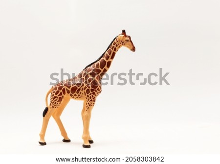Miniature giraffe figurine isolate on a white background. Realistic Animal Toys for Kids