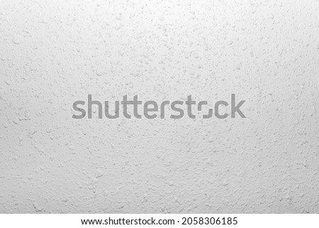 Close-up photo of white colored stucco wall texture.