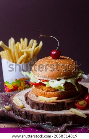 Juicy mexican burger, hamburger or cheeseburger with one chicken patties, with sauce,french fries and cold drink. Concept of mexican fast food. Copy space