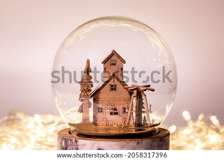 Small wooden house inside the sphere. Wooden house model. 