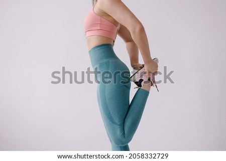 Sports mood picture background. Normal body woman doing leg stretch. Warm up before running. The trainer is doing  exercise. Workout athlete. GYM energy. Muscular healthy body fitness fit. Lifestyle